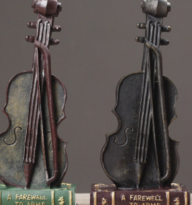 VINTAGE FIGURE VIOLIN ON BOOK RESIN MATERIAL