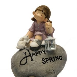 FIGURE SITTING ON STONE WITH LANTERN DESIGN